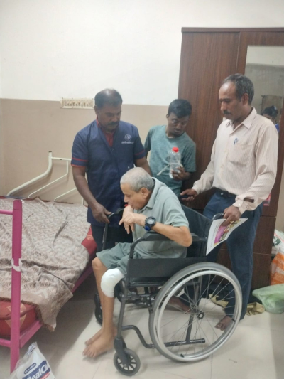 male nurse helping patient in wheelchair